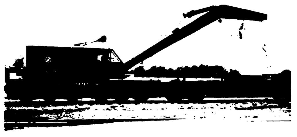 can be especially useful in handling heavy truck assemblies and bulky superstructure units in erecting cars of the knockdown fleet. Figure 2.13 shows a crane in use. Figure 2.13. Typical Railway Crane.