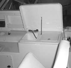 Cockpit Sink and Cooler A sink and cooler is located behind the helm and is equipped with a freshwater sink and a top loading cooler.