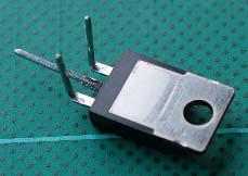 Follow these steps to build a Schottky diode bridge. 1. Bend the pins on the diode and connector like this, cutting off one of the outer angled pins.