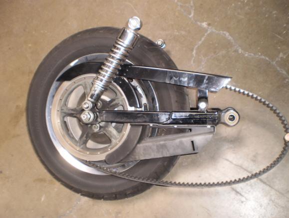 Left and right saddle bags (if so equipped) Left and right rear crash bars, saddlebag rails (if so equipped) Disconnect rear brake line at caliper and remove clamp from swing arm (Note: Prior to