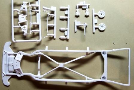 Pic 7 shows the parts to assemble the front suspension. I will detour from the instructions just a little.