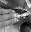 4. Make sure the jack head is positioned so that the rear axle is resting securely between the grooves that are on the jack head. 5. Turn the wheel wrench clockwise to raise the vehicle.
