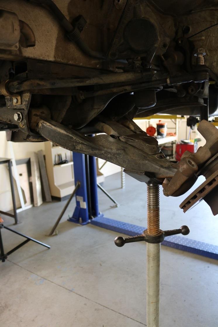 the nut, remove the front and rear lower control arm bolts