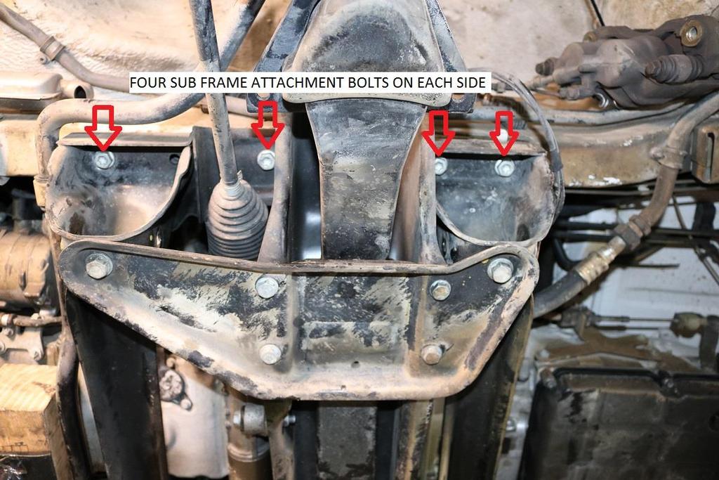 22) Place a jack under the passenger side of the sub frame and remove the four attachment bolts using