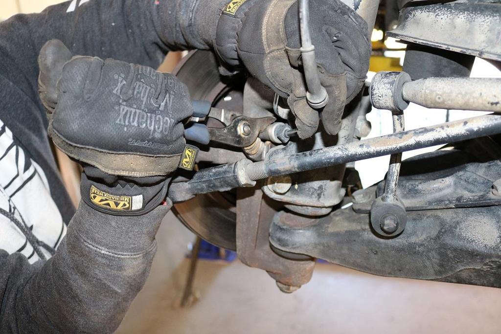 13) Raise the lower control arm about 3/8 (10mm) to remove tension from the strut.