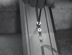 It is important that the bracket be installed with the screw side facing the stringer (wall) so when the rail is turned