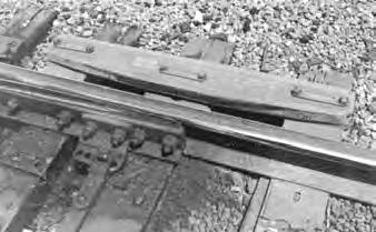 The protector is bolted to the inside of the straight stock rail leading into the switch.