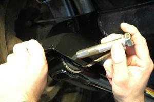 Make sure the bolt that holds the parking brake cable is on the top of the control arm. 9.