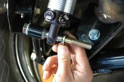 If the shock uses a bearing on the lower, install one of the tapered shock mount spacers on the bolt first.