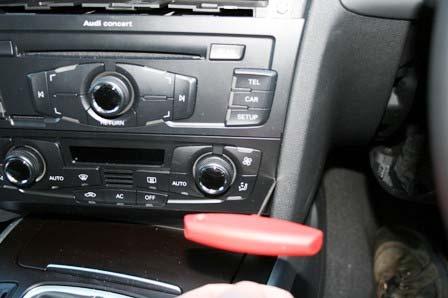 The procedure is to carefully slide the hook tool between the side of the panel and the dashboard to a depth