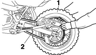 Push the wheel forward, and then remove the drive chain from the rear sprocket. TIP The drive chain does not need to be disassembled in order to remove and install the wheel. 7. Remove the wheel.