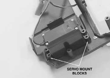 hole. Route the steering servo wire through the slotted hole between the steering servo and the receiver