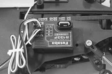 4. Reinstall the radio plate onto the chassis. Make sure to reinstall the washer between the steering bellcrank and the radio plate. 7.