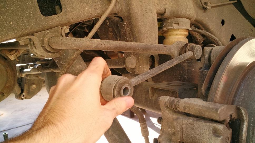 Remove the rear sway bar links lower bolts using an 18mm wrench/socket on both sides.