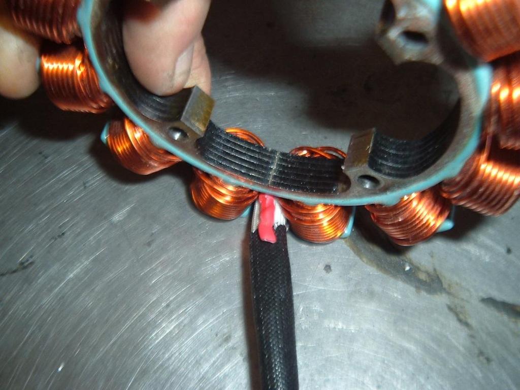 Soldered and heat-shrunk connected wire pair (red) Insulated wire pair to regulator Figure 8 Harness location 11.