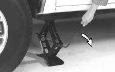 6. Remove any rust or dirt from the wheel bolts, mounting surfaces and spare wheel. 4. Raise the vehicle by turning the jack handle clockwise.