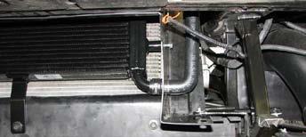 Install the long end of the molded hose onto intercooler reservoir outlet so that the hose extends out and then