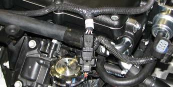 Install the coil cover brackets on top of the ignition coils, then use a 10mm socket