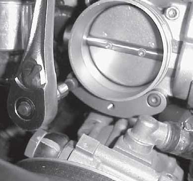 28. Install the arched lower adapter with two 55mm throttle adapter bolts, starting with right side.