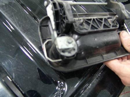 Remove lock cylinder from tailgate handle by pulling out wire spring clip (Figure