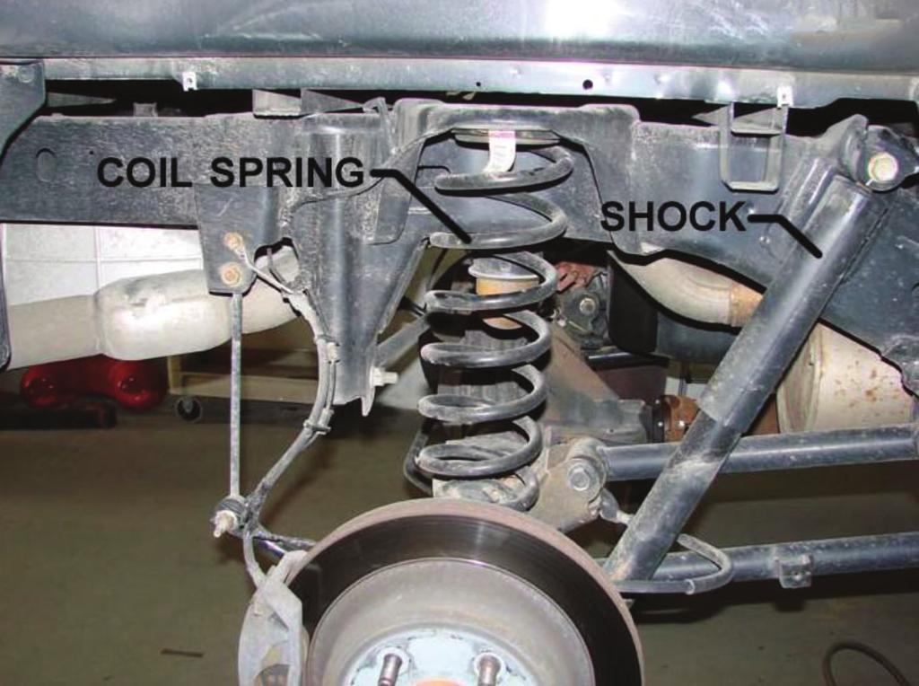 2 BEGIN REMOVING STOCK COIL SPRINGS Support the rear axle with axle stands rated for the vehicle's weight.