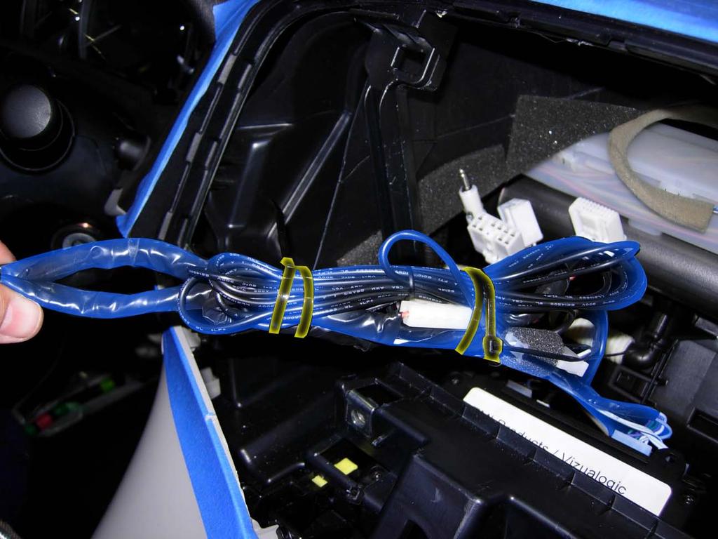 c. Bundle excess microphone and switch cables (highlighted in blue). Use wire ties (highlighted in yellow) to secure to main power harness (Fig. 1-25). d.