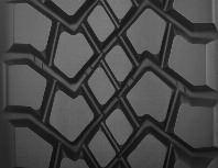 technology, unique two-layer compound designed to minimize internal casing temperature for longer tread and casing life Wing tread design for added