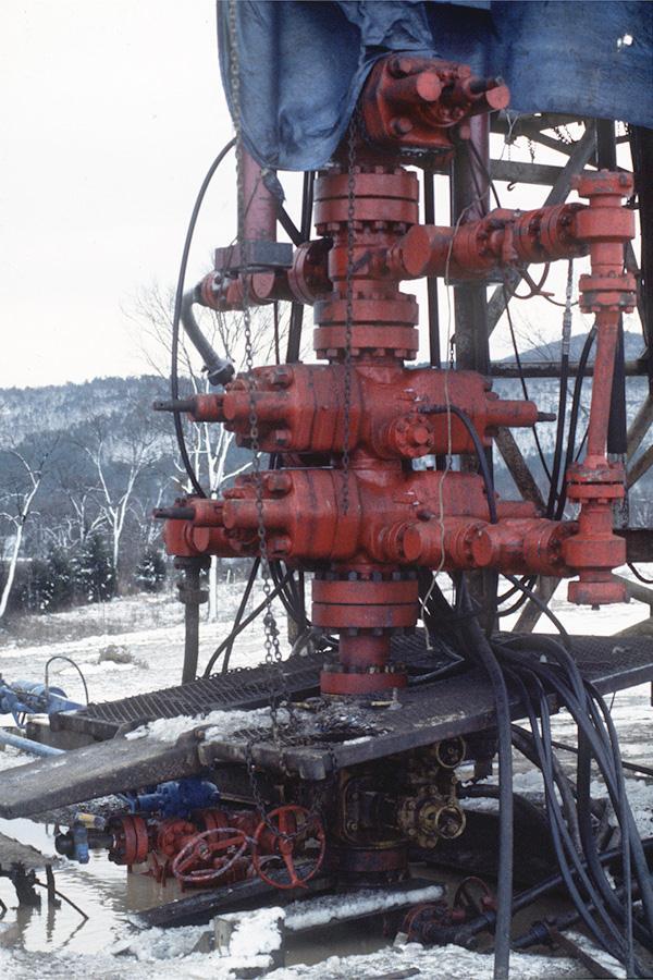 Hydraulic workover unit showing the gas bypass tube between