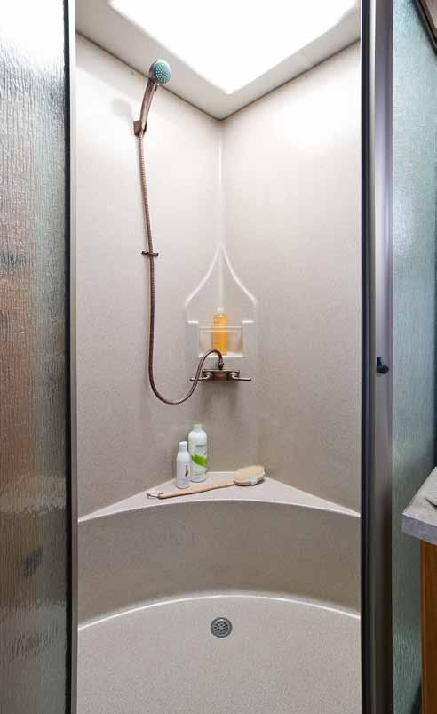 A large, one-piece fiberglass shower and bronze vanity faucet come standard, as does the tile flooring, which is durable and easy to clean.