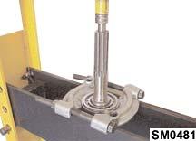 Grasp the input shaft firmly and using a soft mallet, joggle the shaft, gear and bearing out of the case.