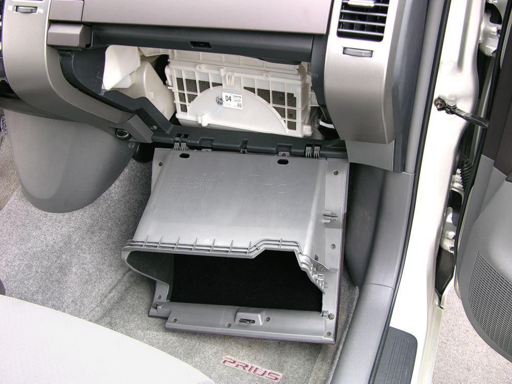 Open the bottom glove-box, and then remove all the contents (since they will end up falling out all over the floor otherwise).
