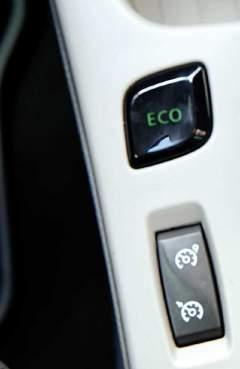 conditioning. The button is next to the gear stick. When the Eco mode is activated, the dashboard goes green.