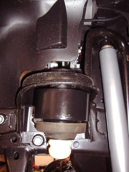 (axle end only). 2. With the items removed, lower the front axle assembly and remove the front coil springs. NOTE: Be careful not to overextend the front drive shaft into the exhaust or skid plate. 3.