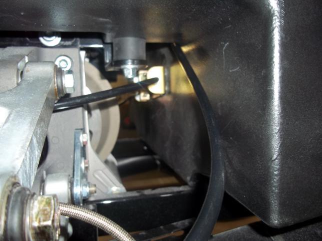 n. Position the cable under the upper control arm and over the anti roll bar housing as seen in Figure 7. o. Install the hand lever cable into the mount opening with the e-clip. p.