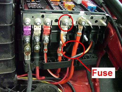 Remove the fuse block cover next to the battery. Route the fused wire as shown in the picture.