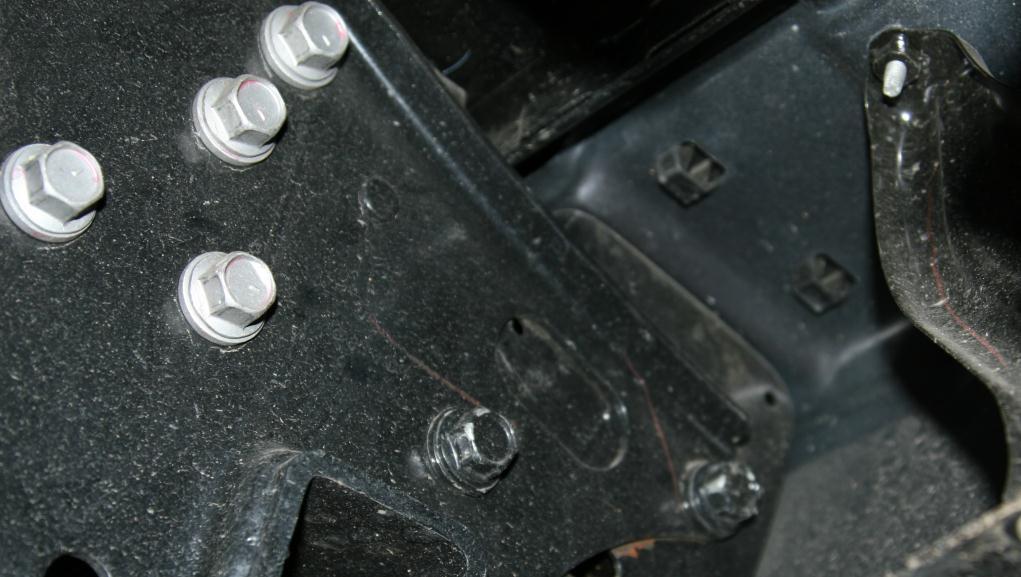 D. Using a 17mm socket or wrench, remove the bolts holding the OEM bumper to the frame rails of the vehicle (2 per side). Figure 4 OEM bumper bolt removal E. Remove the OEM bumper from the vehicle.