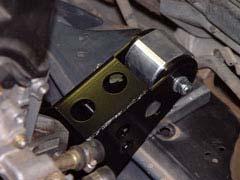 Once the rear bracket is level with the rear engine mount slide the bracket over the