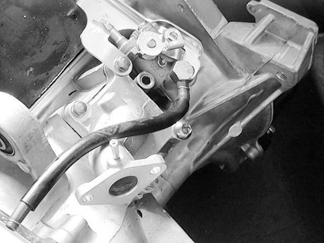 REED VALVE REMOVAL Remove the rear carrier. Remove the frame body cover. Remove the four intake manifold bolts and gasket. Remove the reed valve and gasket.