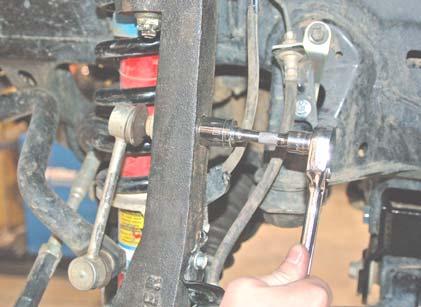 Using a 9/16 socket, bolt the stock front sway bar link to the sway