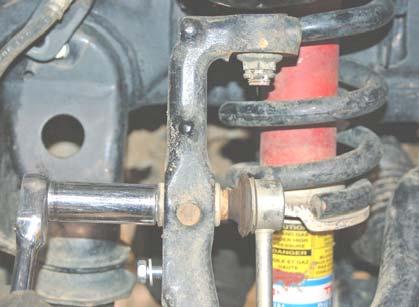 Using a 17mm socket, remove the brake caliper, and rotor. DO NOT let the caliper hang from the brake line.