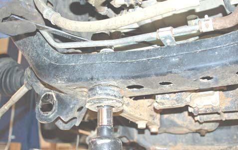 Remove the lower control arm bolts using a 19mm socket and wrench.