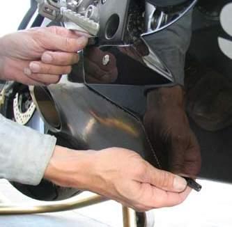 15) Press the inner rivet through the hole and snap tight. 16) Tighten the L/H muffler mount with a 13 mm socket.