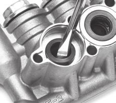 Use two (2) flat tip screwdrivers to create a separation between manifold and crankcase, then remove manifold by hand.