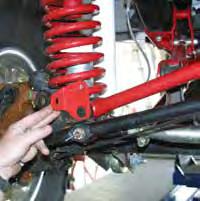 (See Photo # 15) The OEM manufacturer provides the hole in the left lower coil spring mount for you to fasten the coil spring securely to its seat. Install it the same as on the driver side.