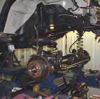 Using care, grind off the OEM lower control arm mounts & paint the exposed surface. (See Photo # 2) 9. Place a jack under the transmission skid plate.