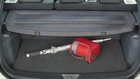 a sliding tray under the passenger seat and a very convenient trunk