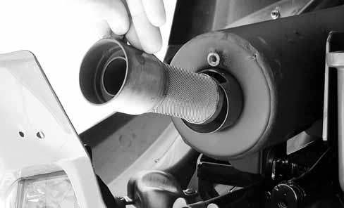 Tap the tailpipe lightly, then use a wire brush to remove any carbon deposits from the spark arrester portion of the