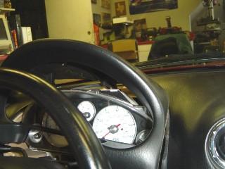 Photo 3-C: Using your fingers, reach between the bezel and the gauge panel and pull to release Photo 3-D: