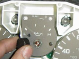 Photo 4-A: Use electrical tape on the face of the gauge panel to protect it Photo 4-B: Using two small screwdrivers, apply even pressure to release the pointer Photo 4-C: Pointer removed from the