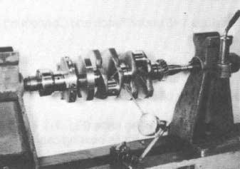 6. Measure the crankshaft for run-out (bend). Mount the crankshaft in a pair of V-blocks (or live centers) and use a dial indicator to measure the run-out in the crankshaft (Fig. 103).